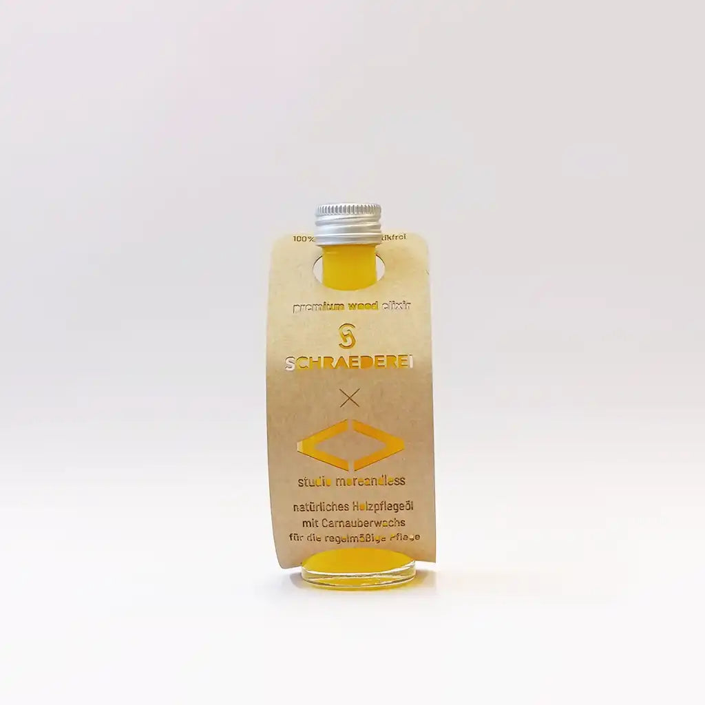 40 ml Flasche premium wood elixir mit individuell gestalteter Banderole als hochwertiges Werbegeschenk für nachhaltige Holzpflege